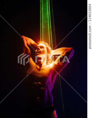 Sporty handsome muscular man portrait under colorful illumination, laser light Sporty handsome muscular man portrait under colorful illumination, laser light 114633604