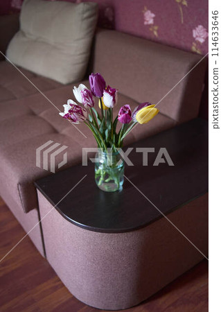 bouquet of multicolored tulips in a transparent jar in the interior bouquet of multicolored tulips in a transparent jar in the interior 114633646
