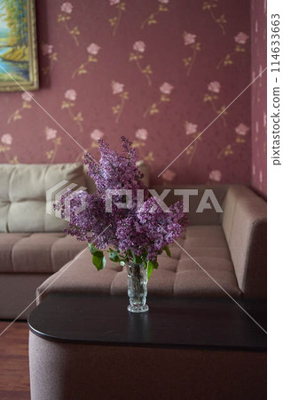 a bouquet of lilacs in a crystal vase in the interior a bouquet of lilacs in a crystal vase in the interior 114633663