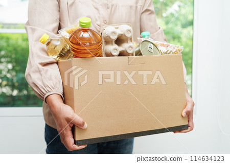 Foodstuffs in donation box for volunteer to help people. Foodstuffs in donation box for volunteer to help people. 114634123