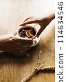 Male and female hand reaching for a cup of tea 114634546