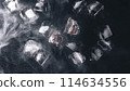 Frozen rings in ice with water and smoke on black background 114634556