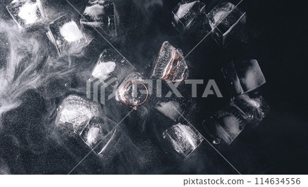 Frozen rings in ice with water and smoke on black background Frozen rings in ice with water and smoke on black background 114634556