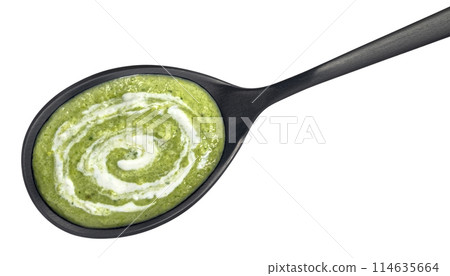 Spinach cream soup in spoon isolated on white background, top view 114635664