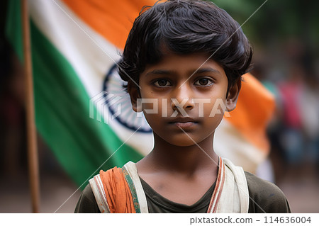 Young Indian boy stands in front of a blurred Indian flag, symbolizing patriotism and national pride. Celebrating Indian Independence Day. Love for the country. Generative AI. 114636004