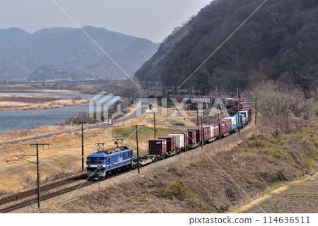 A long freight train that runs fast on Sanyo Road against the backdrop of the Yoshii River, a large river in Okayama Prefecture. 114636511