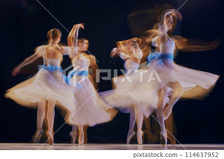 Artistic image of four ballerinas, their synchronized movements forming beautiful blur of white tutus and grace. 114637952