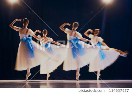 Dancers' rapid movements create a beautiful blur, giving impression of ethereal, ghostly figures on stage. Motion blur effect. 114637977