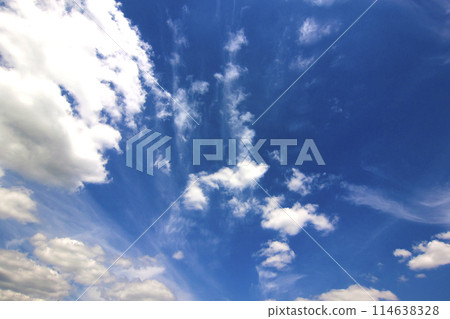 Dramatic blue sky with puffy white clouds in bright clear sunny 114638328