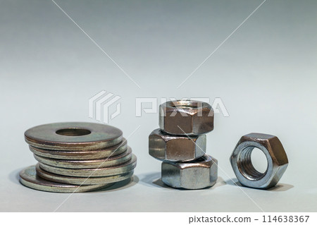 Joiner's accessories. Stacks of metal screw washers and nuts iso 114638367