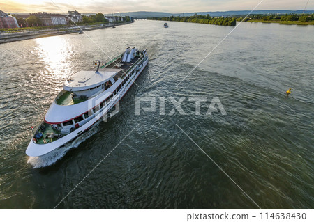 Passenger cruise ship on the Rhine river in Mainz, Germany on a summer evening. Passenger cruise ship on the Rhine river in Mainz, Germany on a summer evening. 114638430