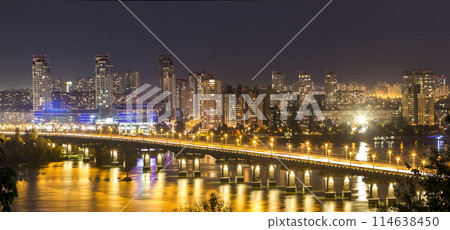 Kyiv (Kiev) city, the capital of Ukraine at night beside the Dnipro (Dniepr) river with reflection in water 114638450