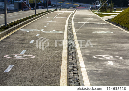 Walk way and bicycle lane signs on the asphalt road surface 114638518