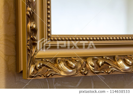 Part of the ornate, golden color carved mirror frame in ancient style. Part of the ornate, golden color carved mirror frame in ancient style. 114638533
