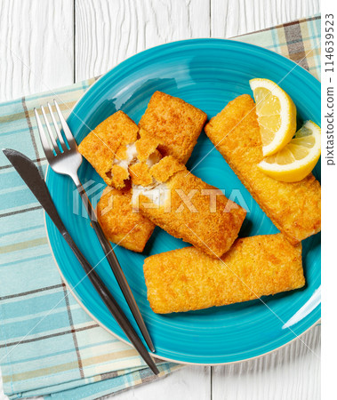 crispy baked battered pollock fillet on a plate 114639523