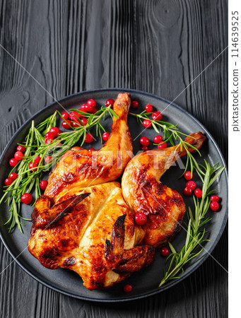 butterflied, spatchcock roast chicken on a plate butterflied, spatchcock roast chicken on a plate 114639525