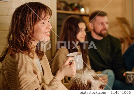 Happy Caucasian woman holding mug enjoying spending winter evening with her husband and daughter at home, copy space Happy Caucasian woman holding mug enjoying spending winter evening with her husband and daughter at home, copy space 114641006