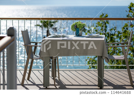 Restaurant table with sea view 114641688