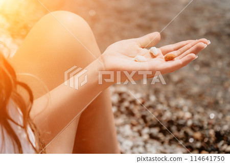 Woman eating milky almond nuts. A young caucasian woman chopping fresh green almond after morning fitness yoga near sea. Only hands are visibly. Healthy vegan food. Slow motion. Close up Woman eating milky almond nuts. A young caucasian woman chopping fresh green almond after morning fitness yoga near sea. Only hands are visibly. Healthy vegan food. Slow motion. Close up 114641750