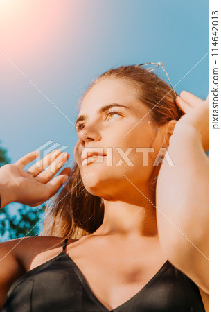Woman summer travel. Happy tourist enjoy taking selfie photo outdoors for memories. Woman traveler posing in summer park on sunset, sharing travel adventure journey Woman summer travel. Happy tourist enjoy taking selfie photo outdoors for memories. Woman traveler posing in summer park on sunset, sharing travel adventure journey 114642013
