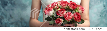woman hands gently holding a lavish bouquet of roses 114642240