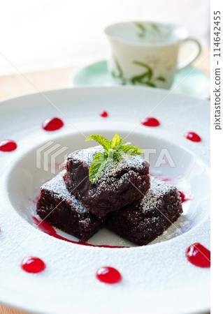 Close-up of chocolate brownie with raspberry sauce 114642455