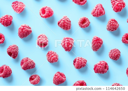 Vibrant Fresh Raspberries on a Blue Background - Fruit Pattern Vibrant Fresh Raspberries on a Blue Background - Fruit Pattern 114642650