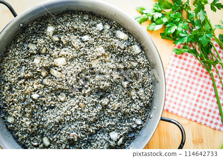 Spanish squid ink paella, black paella (arroz negro) Spanish squid ink paella, black paella (arroz negro) 114642733