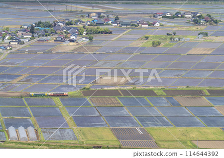 Aizu Basin scenery in early summer and a train on the Tadami Line, aerial view from Futanuma, Aizu Misato Town, Fukushima Prefecture 114644392