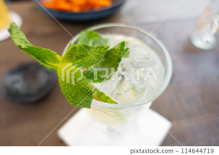 Lemonade with fresh lemon on wooden table background Lemonade with fresh lemon on wooden table background 114644719