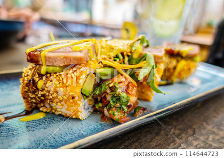 Overhead view of platter of sushi rolls 114644723