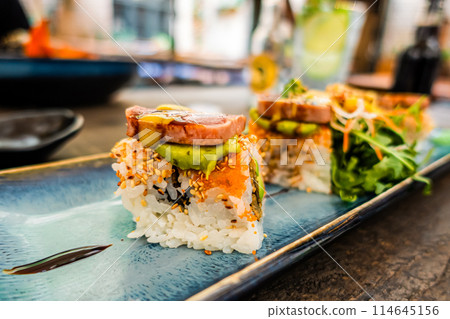 Overhead view of platter of sushi rolls 114645156
