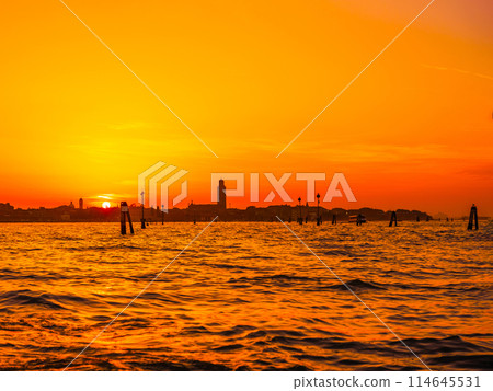silhouettes of Venice at sunset , view from water 114645531