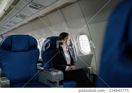 Beautiful Asian businesswoman working with laptop in aeroplane. working, travel, business concept 114645775