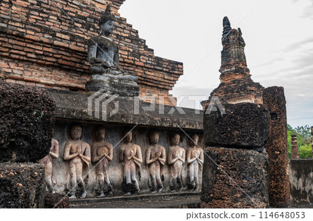 Sculptings of pilgrims on the base of the main chedi in Wat Mahathat temple the most important and impressive temple compound in Sukhothai Historical Park. Sculptings of pilgrims on the base of the main chedi in Wat Mahathat temple the most important and impressive temple compound in Sukhothai Historical Park. 114648053