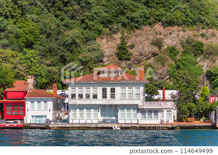 Green mountains of the Asian side of Bosphorus strait, with traditional houses and dense trees in a summer day Green mountains of the Asian side of Bosphorus strait, with traditional houses and dense trees in a summer day 114649499