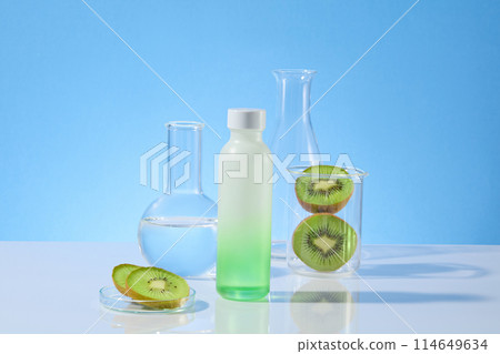 Creative template photo for advertise product extracted from natural kiwi ingredient, a blank label bottle in gradient green color placed in center. Mock up for designing with blank space for design 114649634