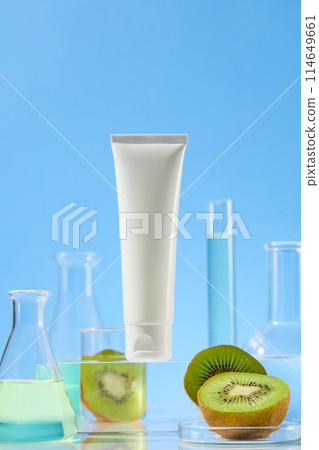 Unique template for advertising with unlabeled cosmetic tube featured on a glass pedestal in center, surrounded by plenty experiment utensil against baby blue background. Front view, space for text 114649661
