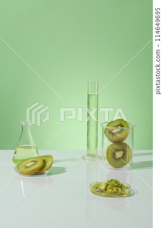 Green background features kiwis contained inside a beaker and petri dishes. Liquid in green color filled inside glassware. Kiwis can reduce tiredness and improve energy levels Green background features kiwis contained inside a beaker and petri dishes. Liquid in green color filled inside glassware. Kiwis can reduce tiredness and improve energy levels 114649695