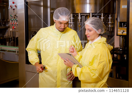 Team technician checking and maintenance quality of producing automated machine bottling wine. Team technician checking and maintenance quality of producing automated machine bottling wine. 114651128