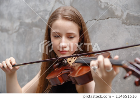 Young woman with white hair and blonde hair playing violin. beautiful musician female performer Young woman with white hair and blonde hair playing violin. beautiful musician female performer 114651516