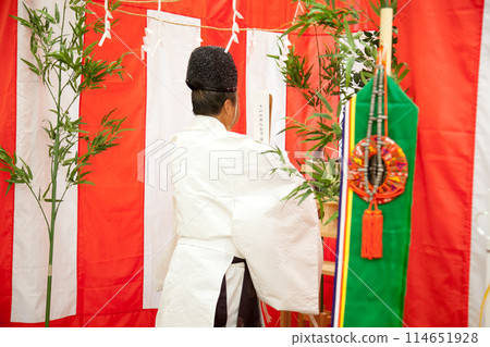 Image of a Shinto priest offering a prayer at a Japanese ceremony such as a ground-breaking ceremony Image of a Shinto priest offering a prayer at a Japanese ceremony such as a ground-breaking ceremony 114651928