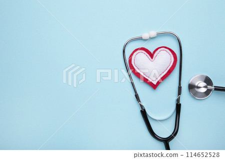 Stethoscope and heart on a blue background. Health, medicine Stethoscope and heart on a blue background. Health, medicine 114652528