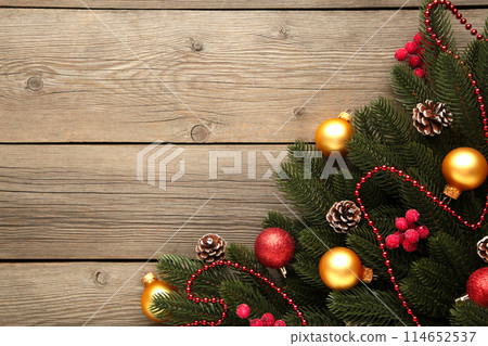 Christmas decoration. Fir-tree branch with red and gold balls on grey background 114652537
