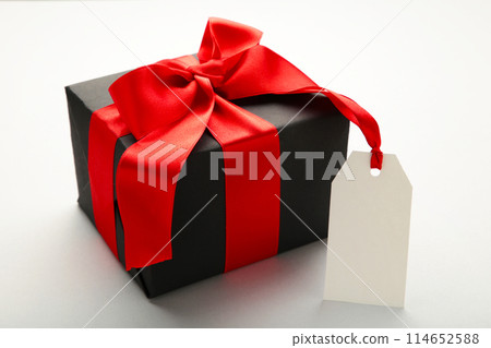 Black gift box with sale tag on grey background 114652588