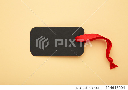 Black sale tag on beige background. Black friday 114652604