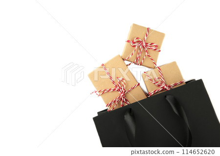 Black shopping bag with gifts isolated on a white background. Black shopping bag with gifts isolated on a white background. 114652620