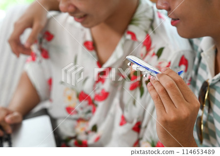 Gay couple holding airplane model. Traveling, vacation and transportation concept 114653489