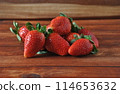 Sweet fresh strawberries on wooden table 114653632