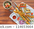 Barbecue meat. Chicken kebab. Chicken Shashlik with vegetables on wooden background. Rustic style. Top view 114653664